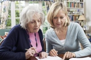 Woman helping elderly mother