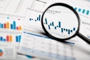 Magnifying glass on business charts