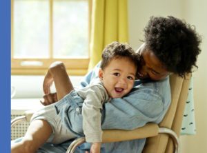 mother sitting in a chair with baby in her lap